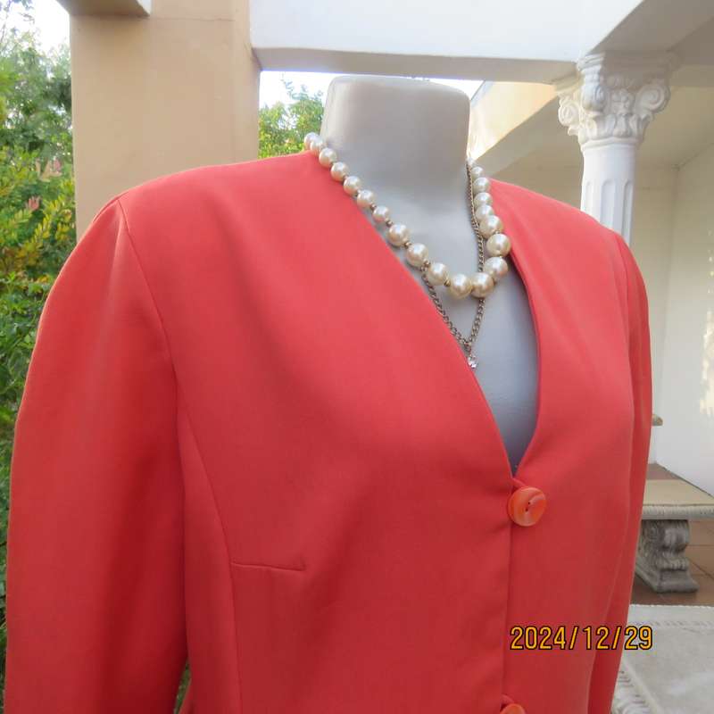 Stunning boutique made papaya colour long sleeve lined collarless jacket.Size 38.Poly-viscose blend.