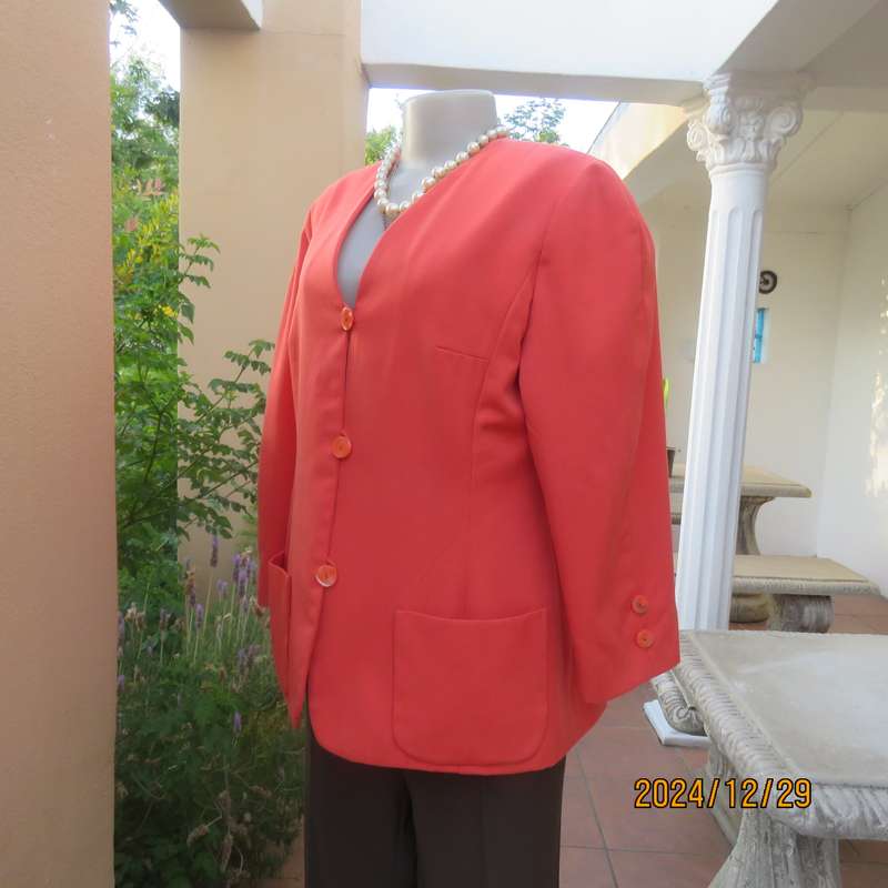 Stunning boutique made papaya colour long sleeve lined collarless jacket.Size 38.Poly-viscose blend.