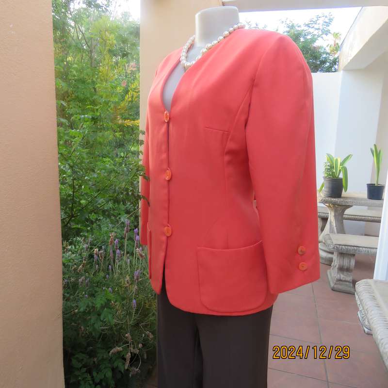 Stunning boutique made papaya colour long sleeve lined collarless jacket.Size 38.Poly-viscose blend.