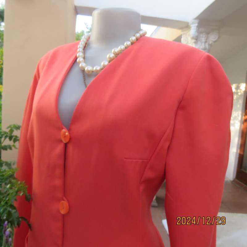 Stunning boutique made papaya colour long sleeve lined collarless jacket.Size 38.Poly-viscose blend.
