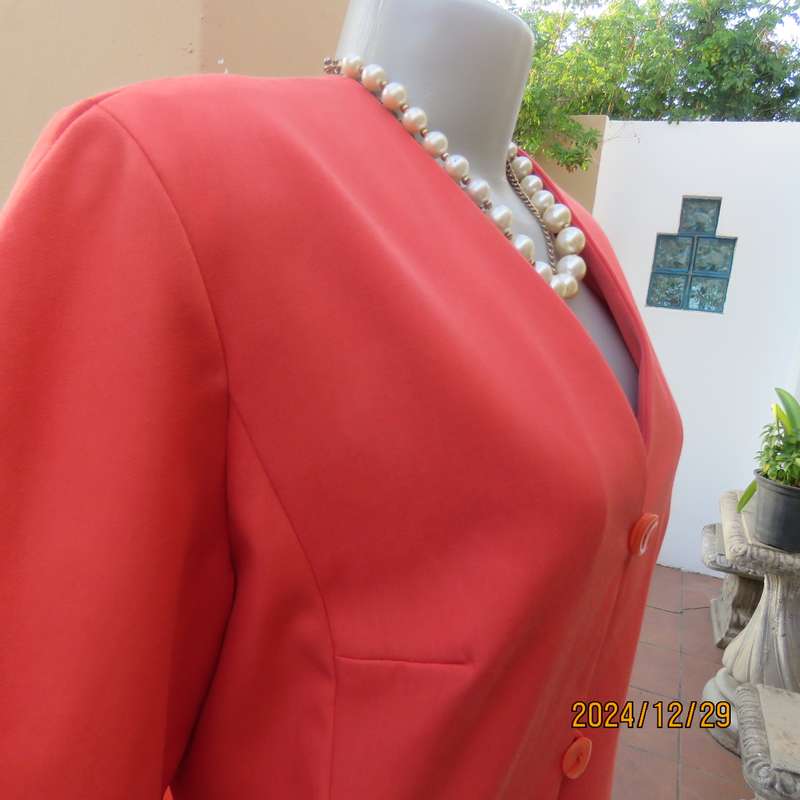 Stunning boutique made papaya colour long sleeve lined collarless jacket.Size 38.Poly-viscose blend.