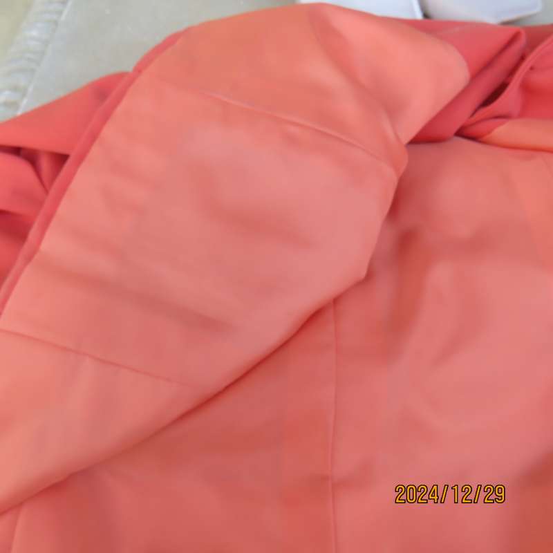 Stunning boutique made papaya colour long sleeve lined collarless jacket.Size 38.Poly-viscose blend.