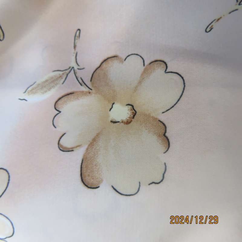 Tastefully printed flowers on pale peach background silky polyester short sleeve top.Size 40. As new