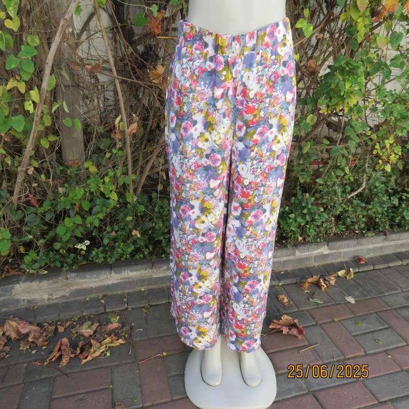 Colourful casual floral wide legged pants. Wide elasticated waist. Tasteful print. Size 42