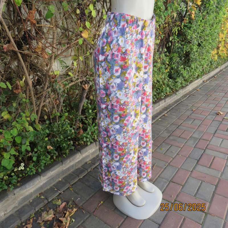 Colourful casual floral wide legged pants. Wide elasticated waist. Tasteful print. Size 42