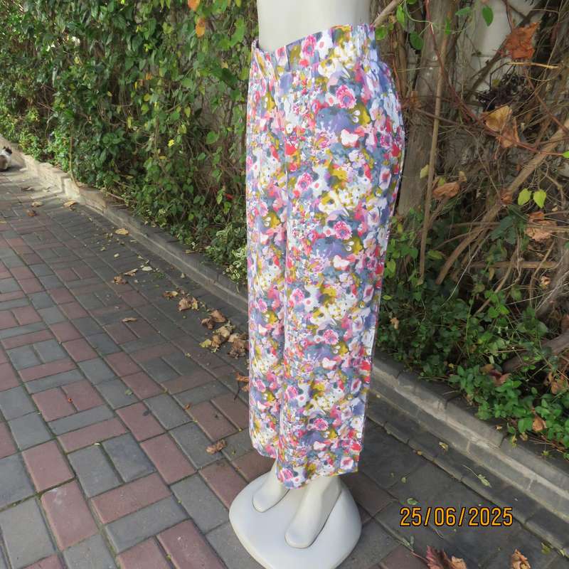 Colourful casual floral wide legged pants. Wide elasticated waist. Tasteful print. Size 42
