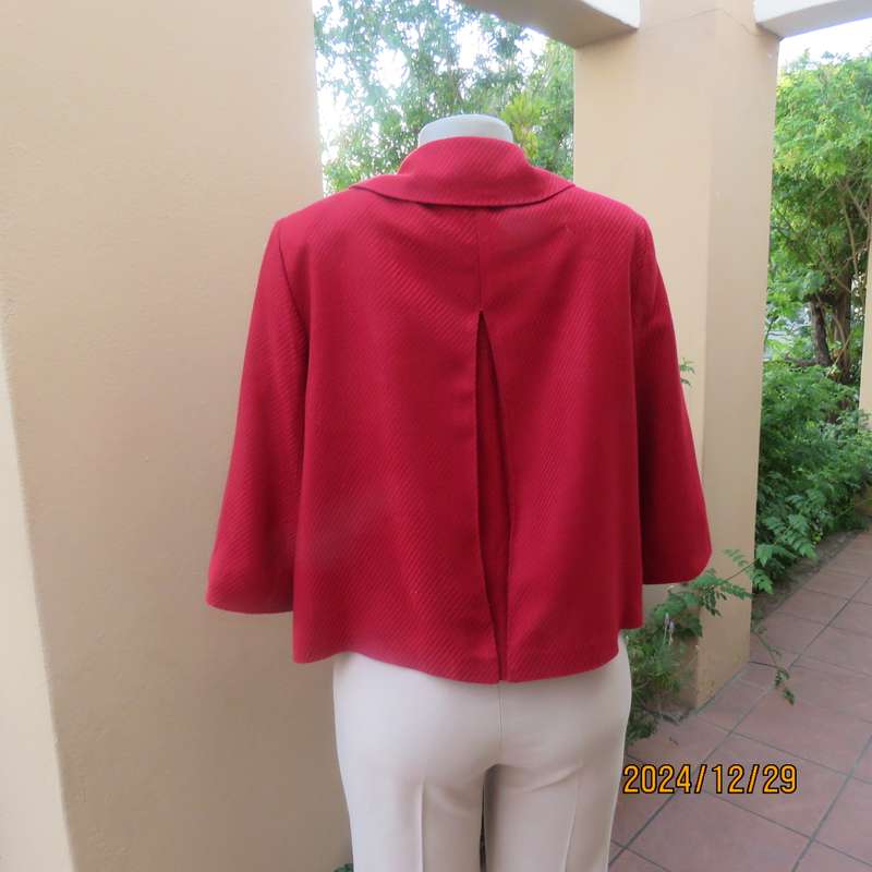 High quality red LTD Woman fly away short jacket in ribbed acrylic.Fully lined. Size 38. As new.