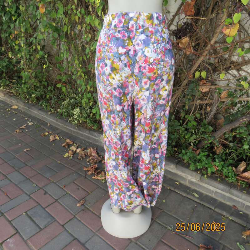 Colourful casual floral wide legged pants. Wide elasticated waist. Tasteful print. Size 42
