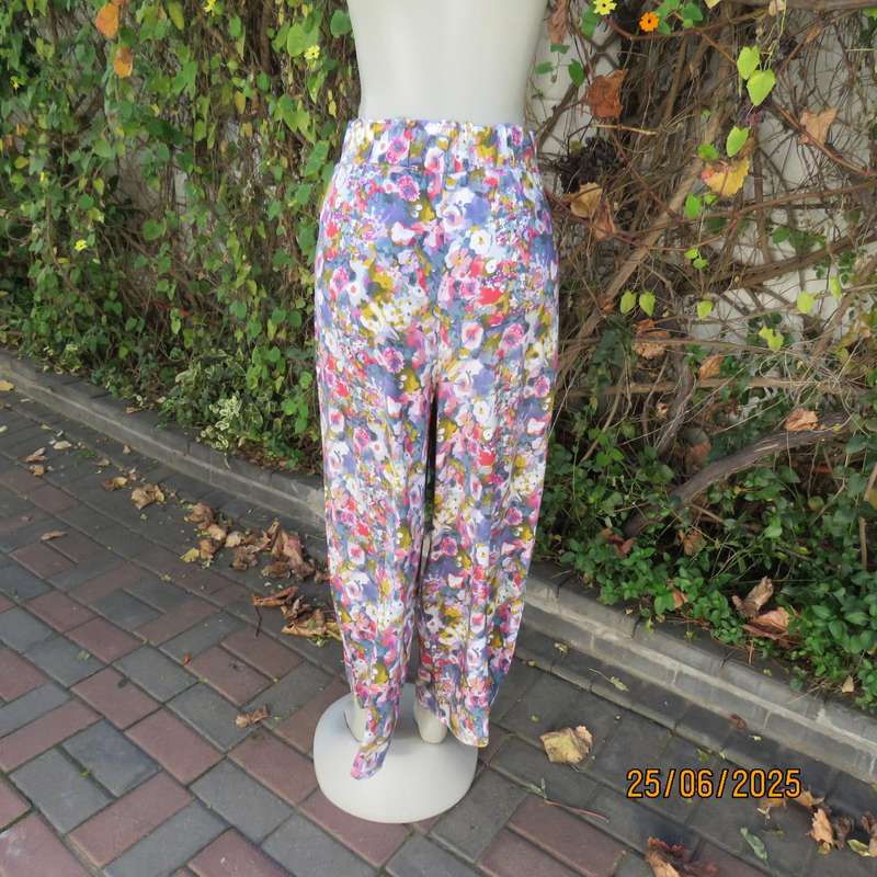 Colourful casual floral wide legged pants. Wide elasticated waist. Tasteful print. Size 42