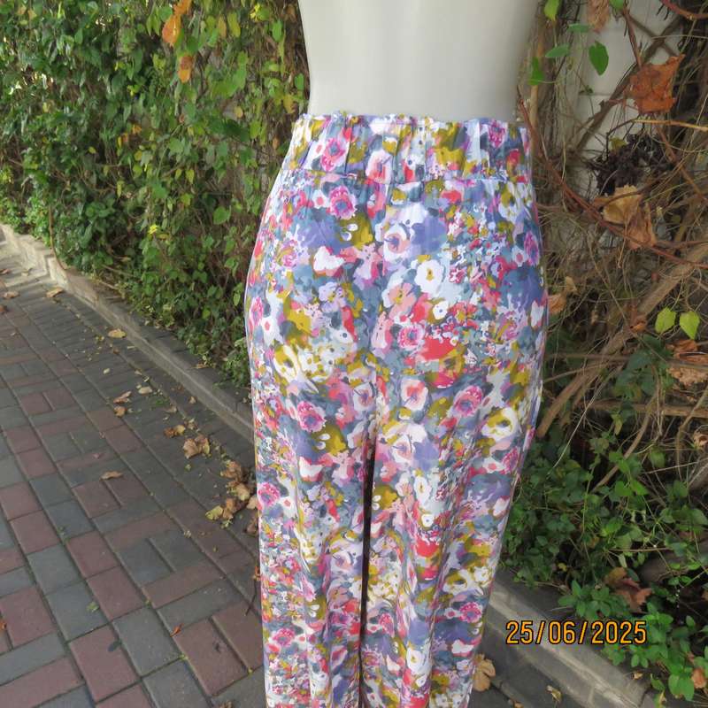 Colourful casual floral wide legged pants. Wide elasticated waist. Tasteful print. Size 42