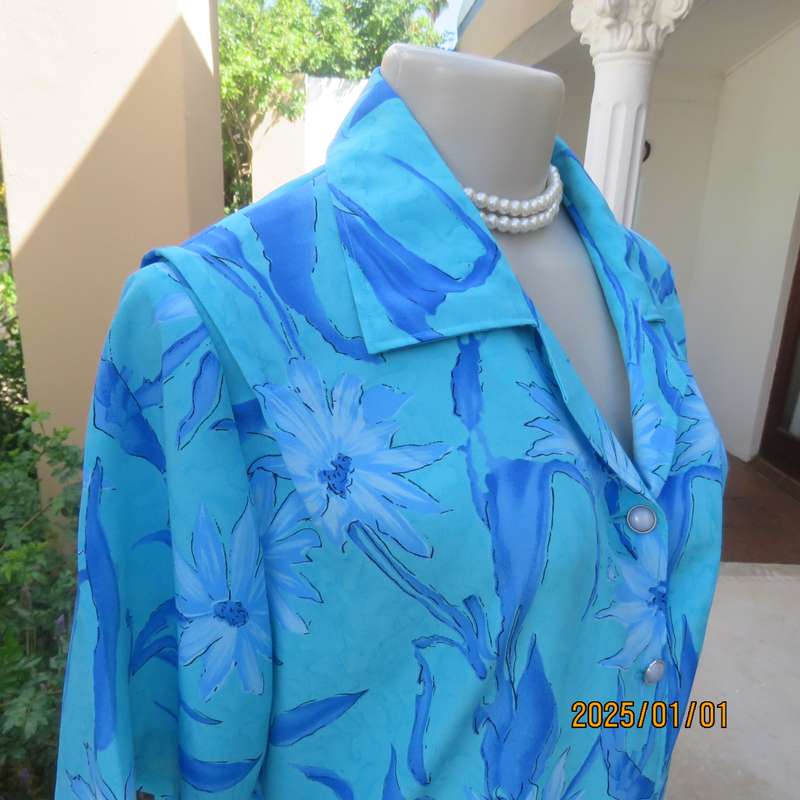 Beautiful in blue. Floral short sleeve polyester top with button down front and open collar. Size 40