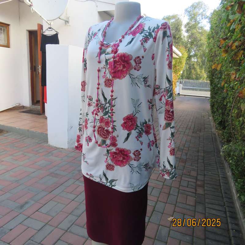 White V neck stretch polyester slip over top with crimson-green flowers. Size 38
