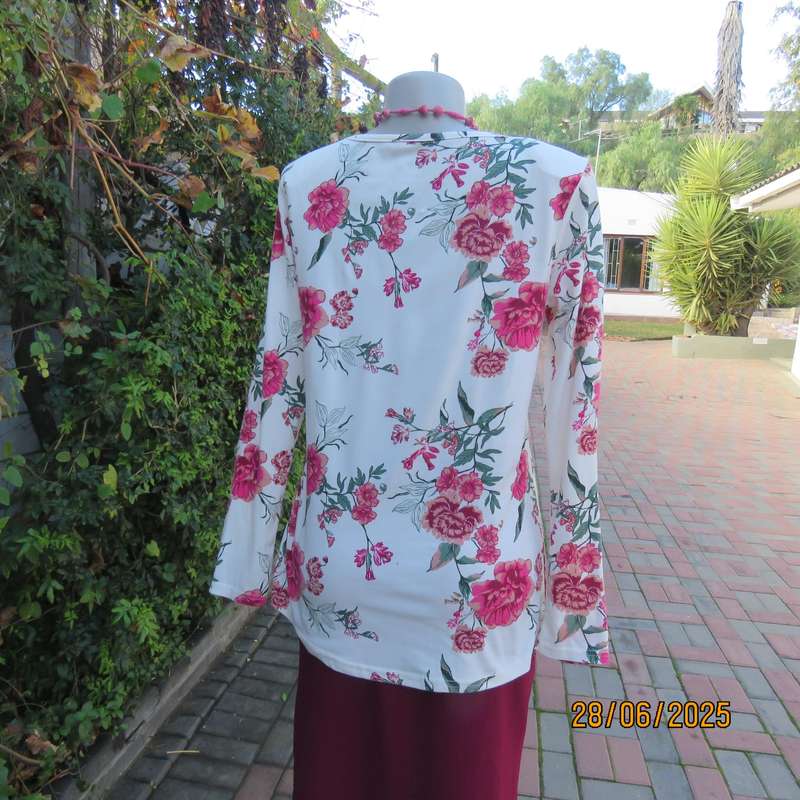White V neck stretch polyester slip over top with crimson-green flowers. Size 38