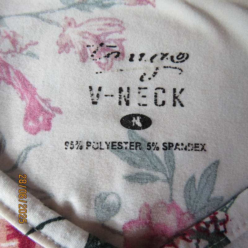White V neck stretch polyester slip over top with crimson-green flowers. Size 38