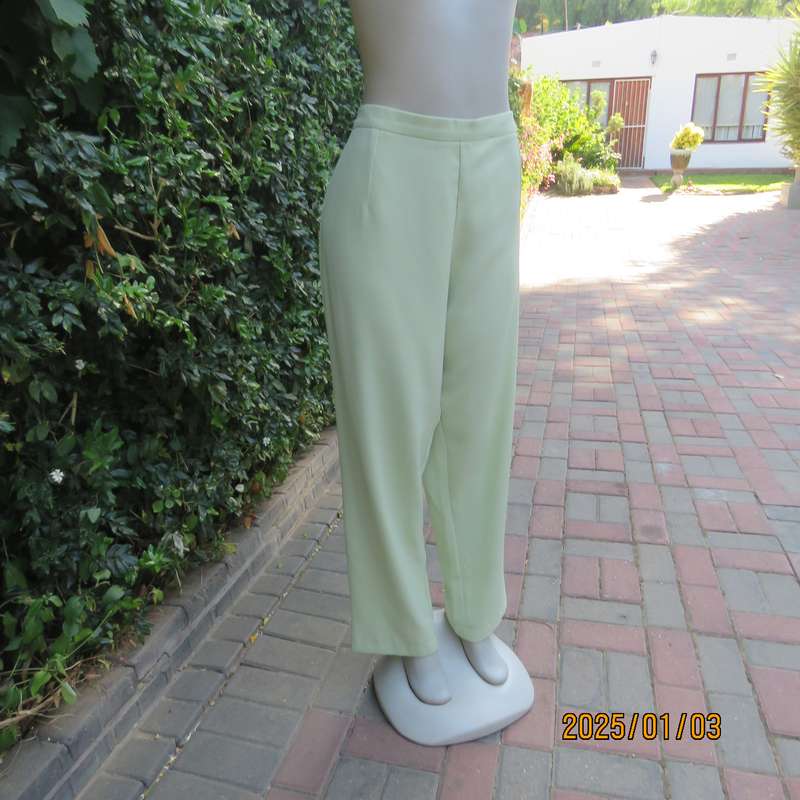 Pastel green dress pants with tapered legs. Flat front-elasticated back. Size 44. Firm textured poly