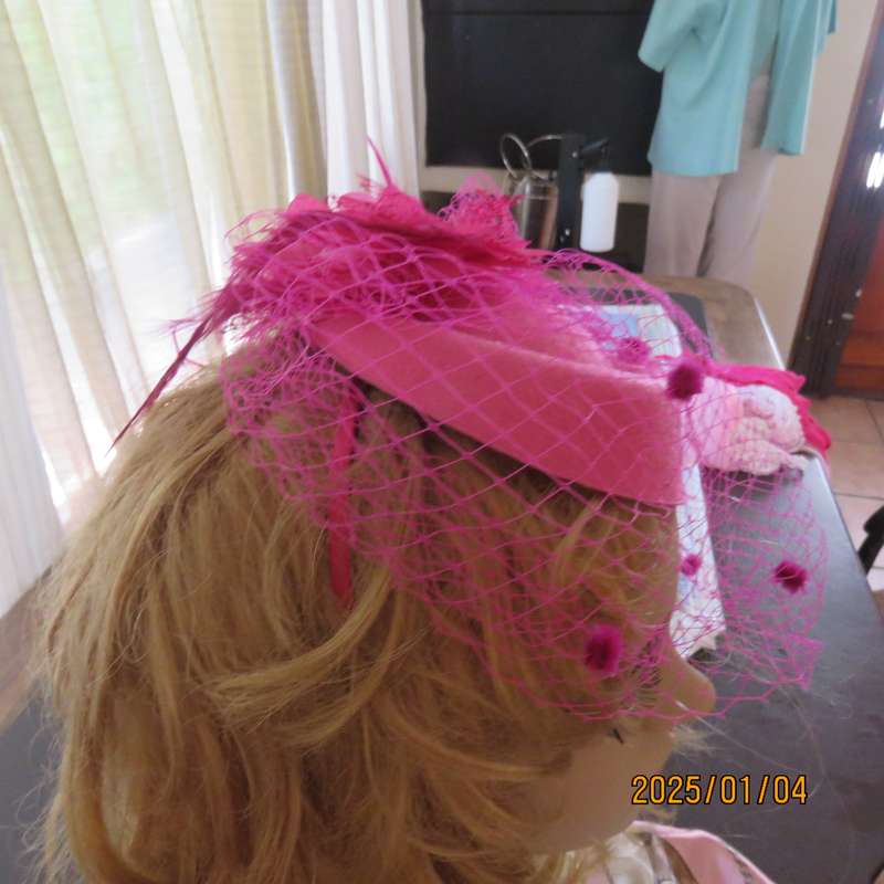 Magenta pink pillbox style fascinator.Netting on front.Flower and feathers. Thin satin alice band.