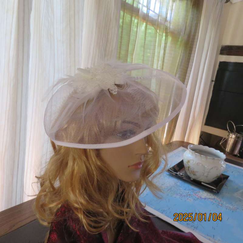Beautiful styled light cream round mesh fascinator with flower-feathers and beads. Thin satin band,