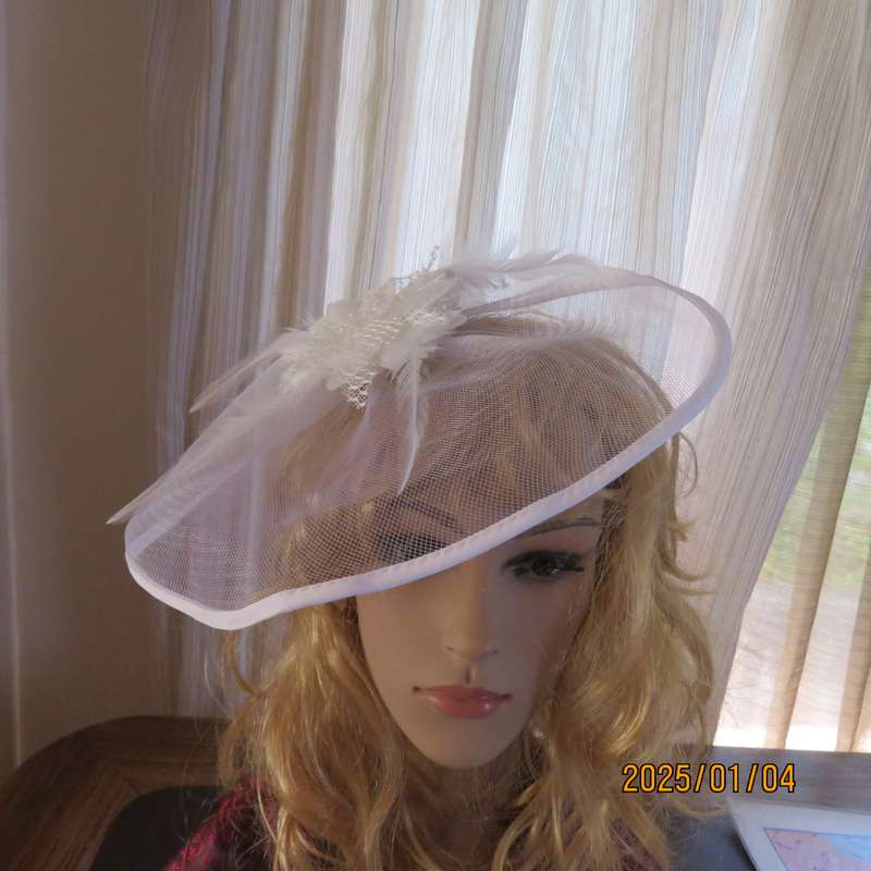 Beautiful styled light cream round mesh fascinator with flower-feathers and beads. Thin satin band,