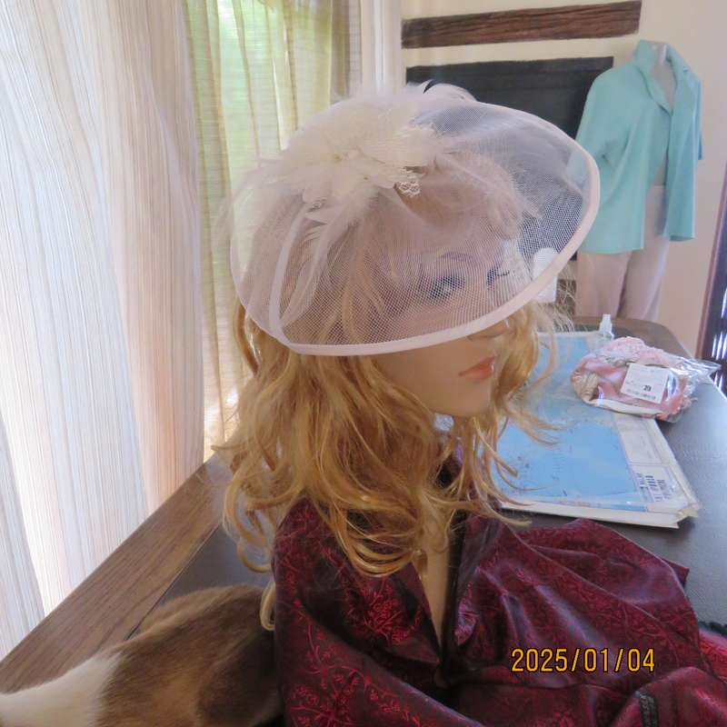 Beautiful styled light cream round mesh fascinator with flower-feathers and beads. Thin satin band,