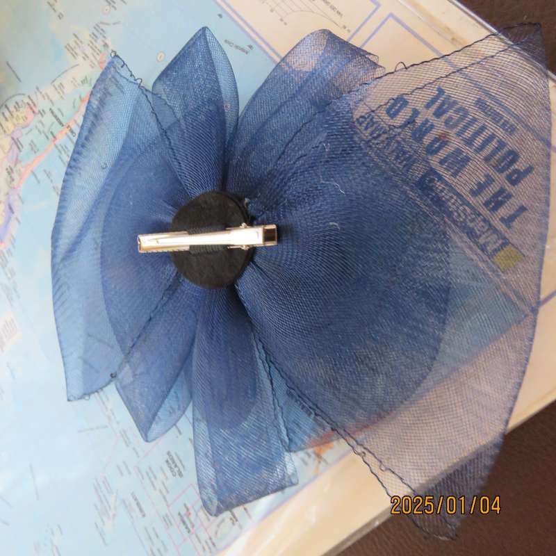 Make a statement wearing this navy double bow mesh fascinator with flower and feathers. New item