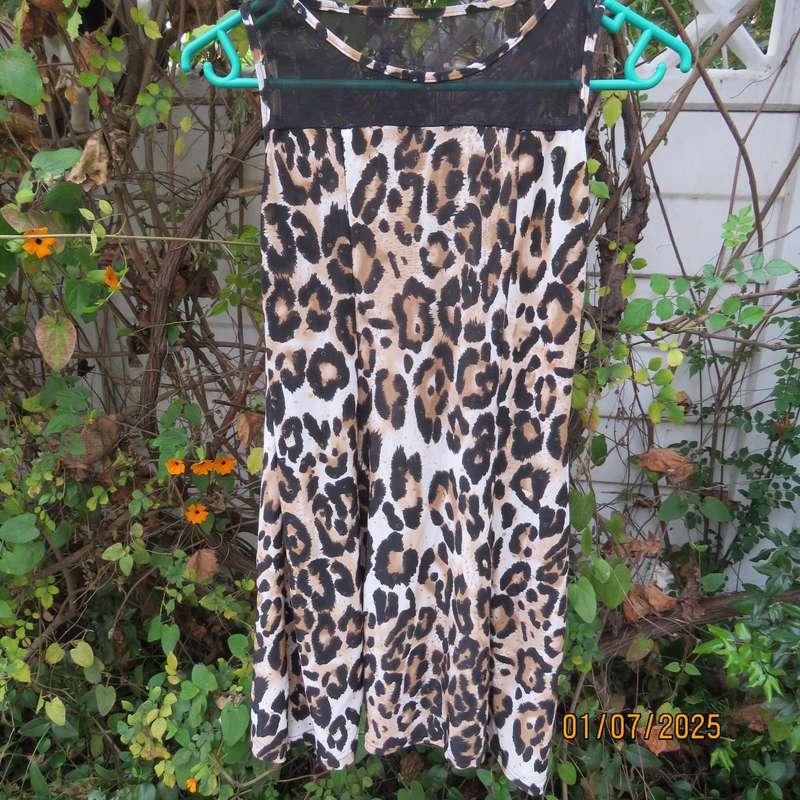 Animal print sleeveless stretch polyester dress with black mesh yoked. Girl 9 to 10yr