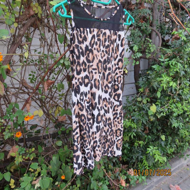Animal print sleeveless stretch polyester dress with black mesh yoked. Girl 9 to 10yr