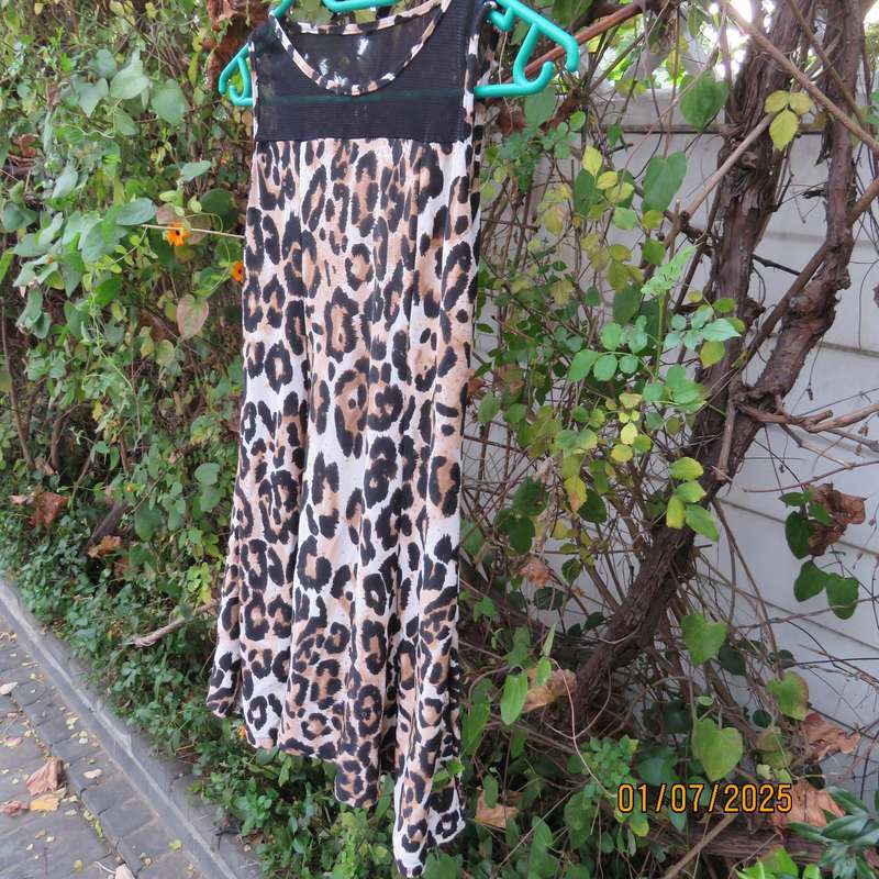 Animal print sleeveless stretch polyester dress with black mesh yoked. Girl 9 to 10yr