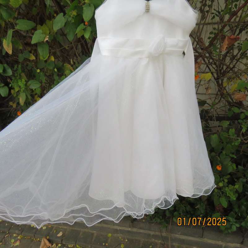 White flower girl tulle dress in 6 layers with adjustable shoulder straps. Size 7-8