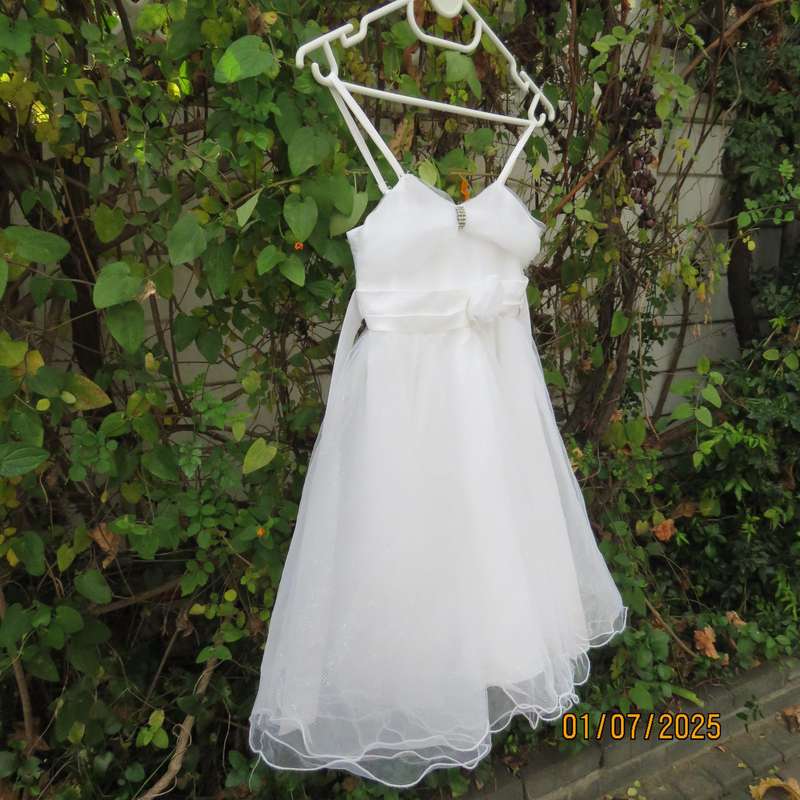 White flower girl tulle dress in 6 layers with adjustable shoulder straps. Size 7-8