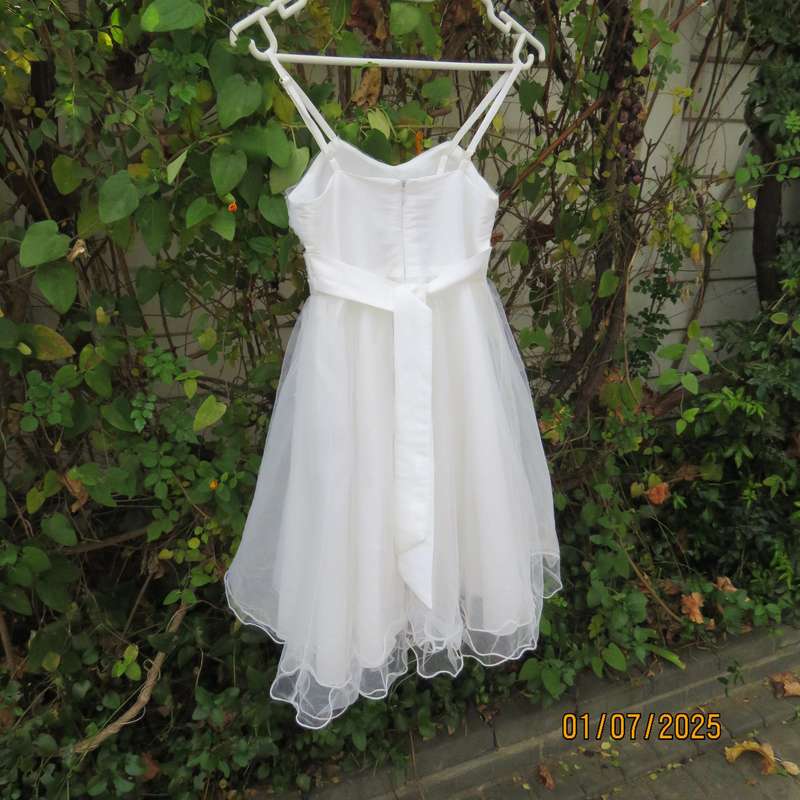 White flower girl tulle dress in 6 layers with adjustable shoulder straps. Size 7-8