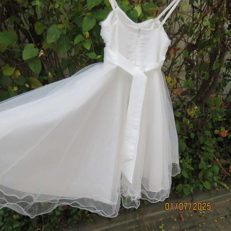 White flower girl tulle dress in 6 layers with adjustable shoulder straps. Size 7-8