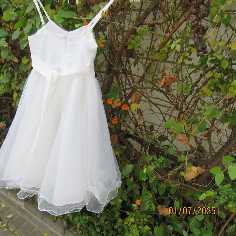 White flower girl tulle dress in 6 layers with adjustable shoulder straps. Size 7-8