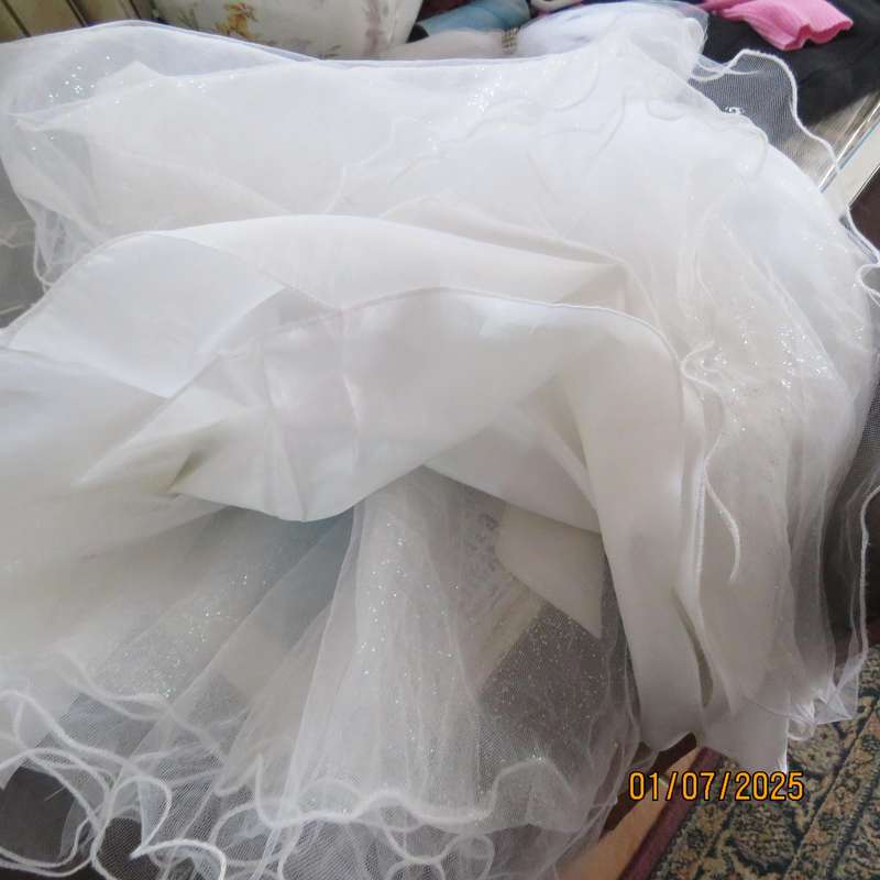 White flower girl tulle dress in 6 layers with adjustable shoulder straps. Size 7-8