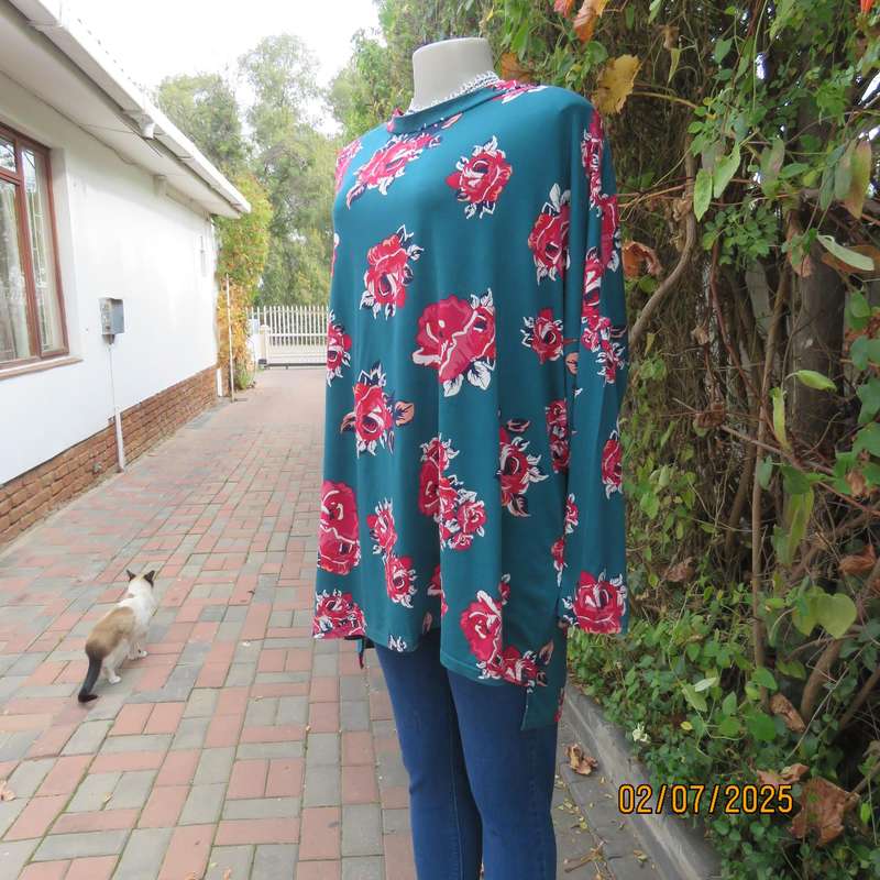 Dark jade slip over stretch polyester top with red-white flowers. Long sleeves. Size 50