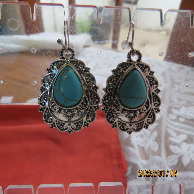 Vintage style earrings with turquoise stone with silver plated backing. New item