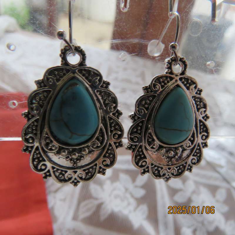 Vintage style earrings with turquoise stone with silver plated backing. New item