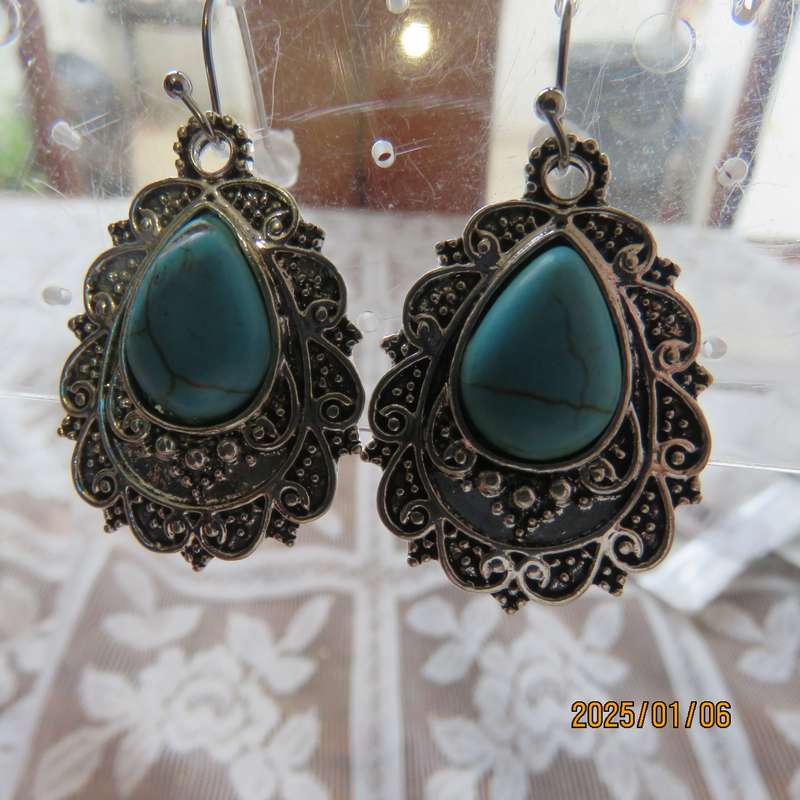 Vintage style earrings with turquoise stone with silver plated backing. New item
