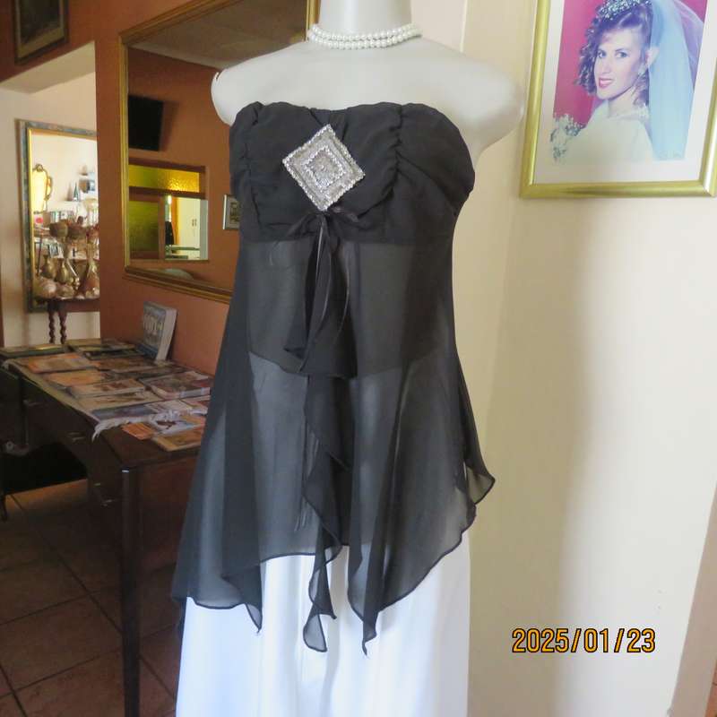Luxury WWW black evening top size 32. Strapless. Bra area double.Rest sheer high-low polyester.