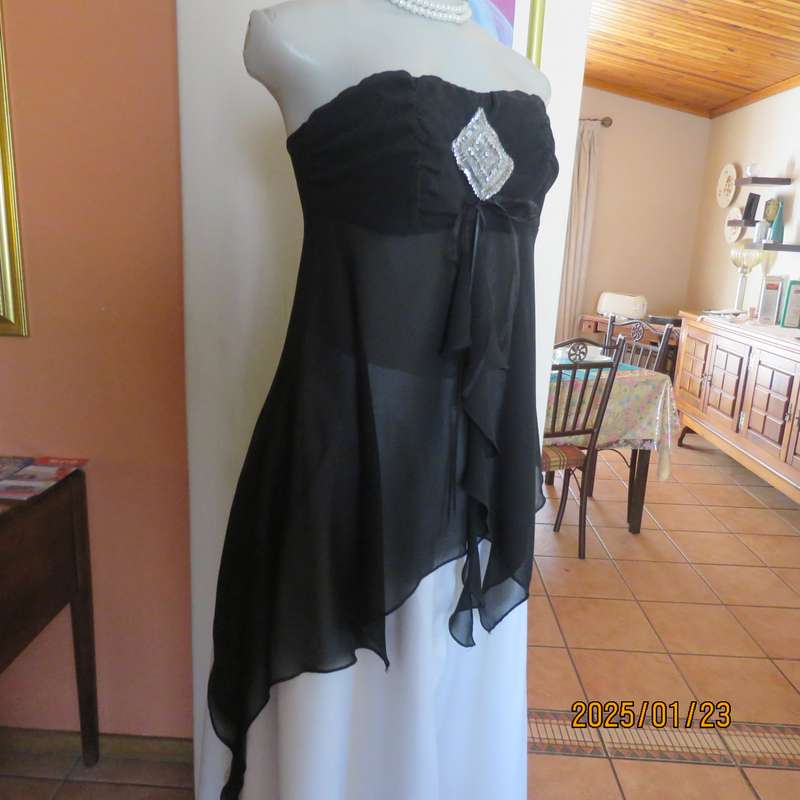 Luxury WWW black evening top size 32. Strapless. Bra area double.Rest sheer high-low polyester.