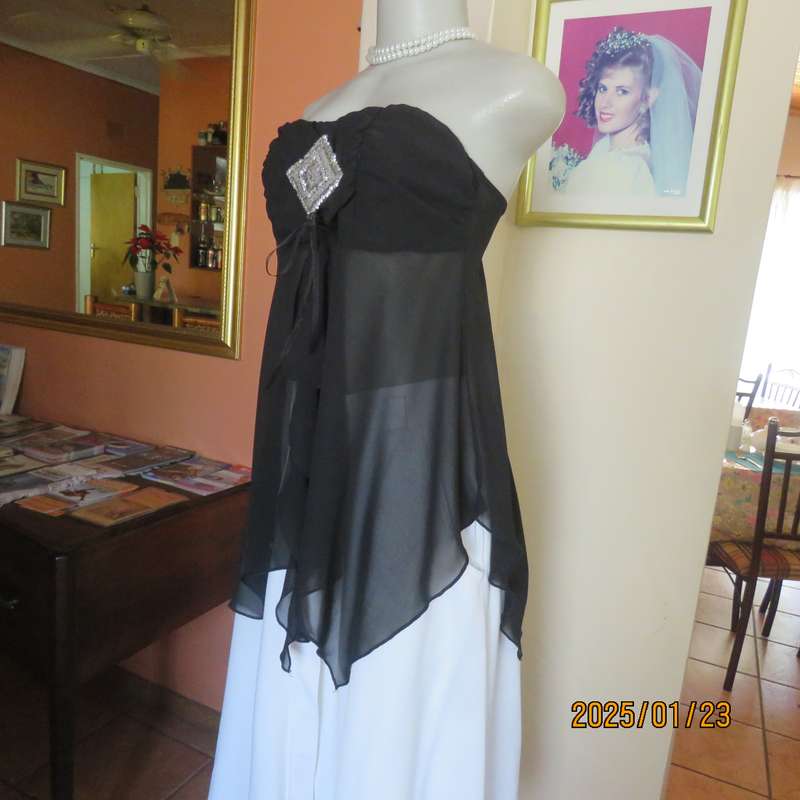 Luxury WWW black evening top size 32. Strapless. Bra area double.Rest sheer high-low polyester.