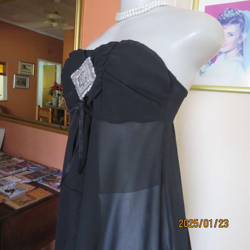 Luxury WWW black evening top size 32. Strapless. Bra area double.Rest sheer high-low polyester.