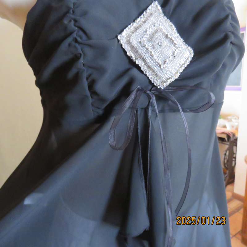 Luxury WWW black evening top size 32. Strapless. Bra area double.Rest sheer high-low polyester.
