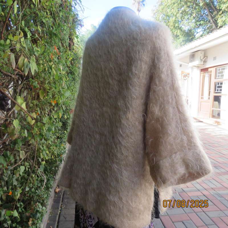 Pure mohair rich cream knitted jacket from Scotland. Size 38 to 42. Knit on elbow sleeves. Open