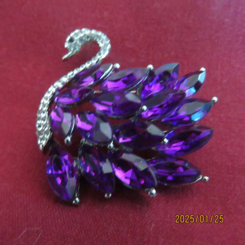 Elegant silver plated swan 4cm x 4cm brooch with purple stones and faux diamond neck area. New item