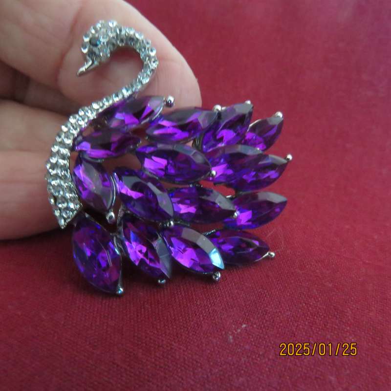 Elegant silver plated swan 4cm x 4cm brooch with purple stones and faux diamond neck area. New item
