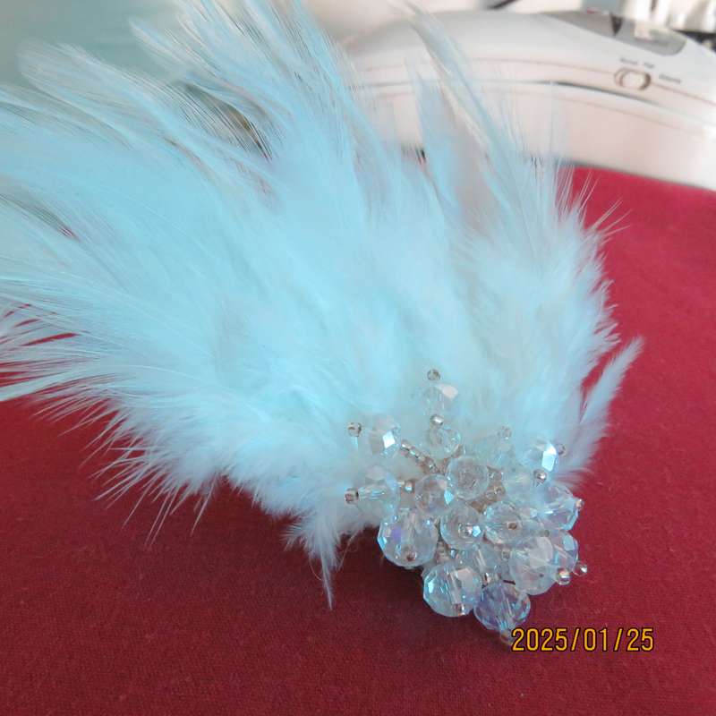 Chic romantic white feather brooch. Faux crystal flower center. Suitable for smart event. New item.