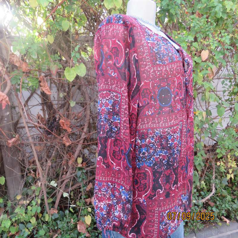 Maroon sheer polyester paisley-floral print in blue-white long sleeve top. Size 42.