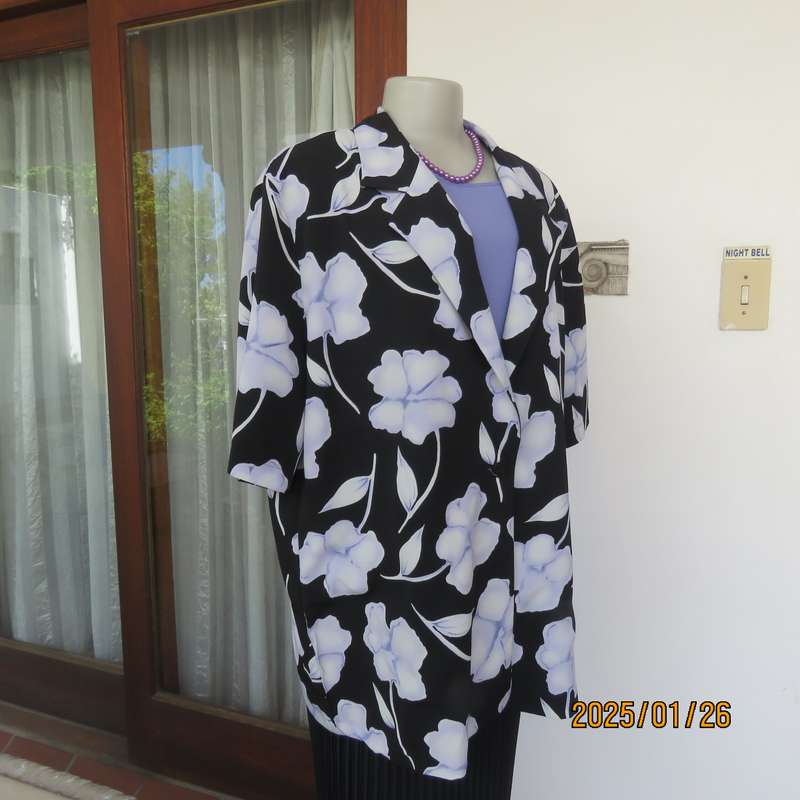 PARK AVENUE  short sleeve top-jacket. Black with very pale lilac flowers. Size 44.One button closure