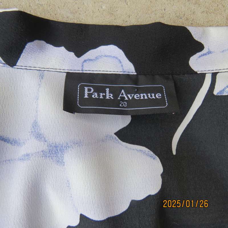 PARK AVENUE  short sleeve top-jacket. Black with very pale lilac flowers. Size 44.One button closure