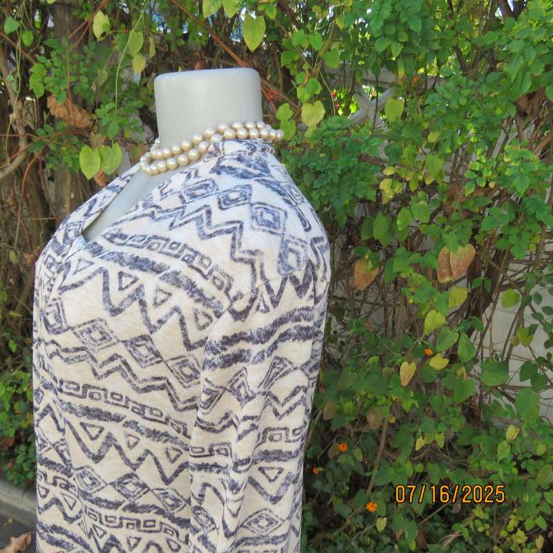 Calf length rich cream with horizontal graphic pattern stretch polyester coat. Size 38